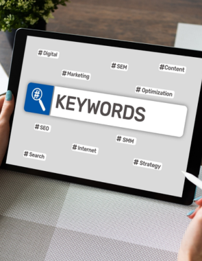 Keywords on tablet with hands holding it a collection of data keywords for SEO marketing.