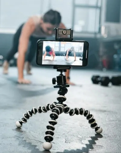 The video camera is capturing a person doing a workout to share on social media platforms.